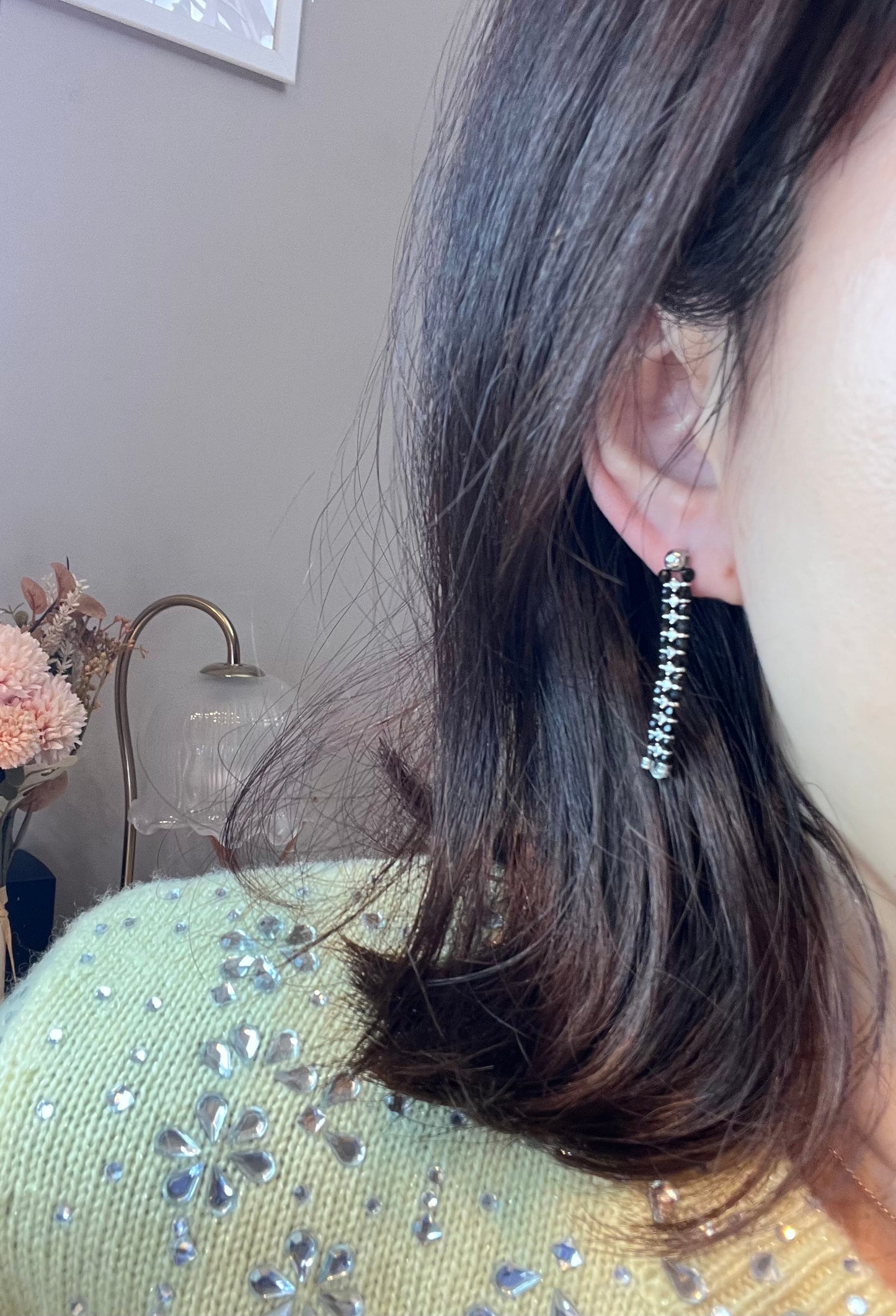 Wearing two pearl, turquoise and black spinel earrings