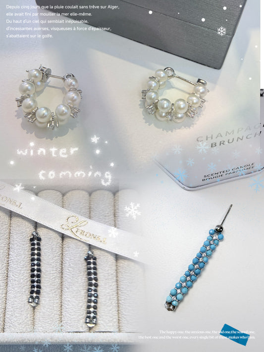 Wearing two pearl, turquoise and black spinel earrings