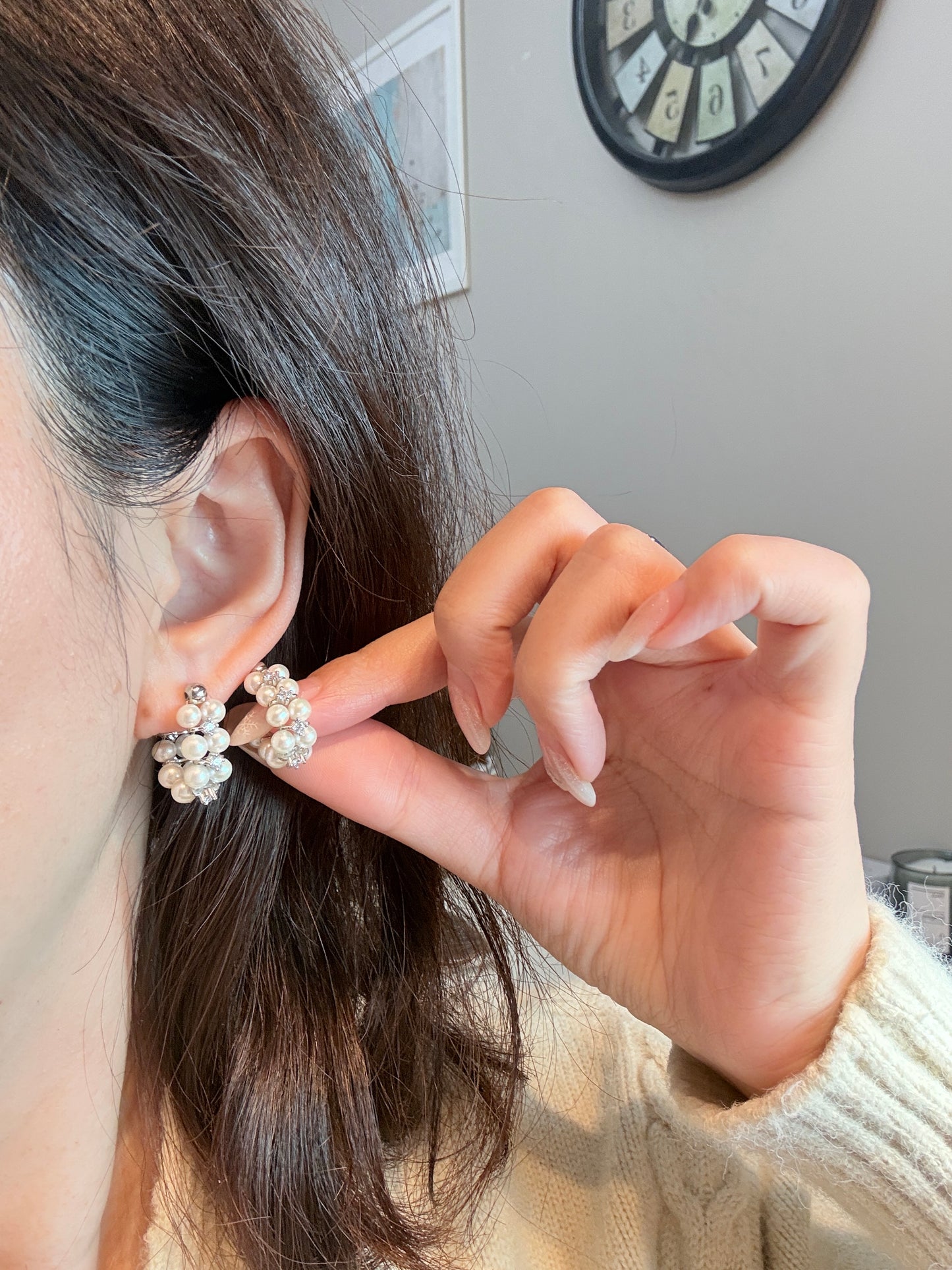 Wearing two pearl, turquoise and black spinel earrings