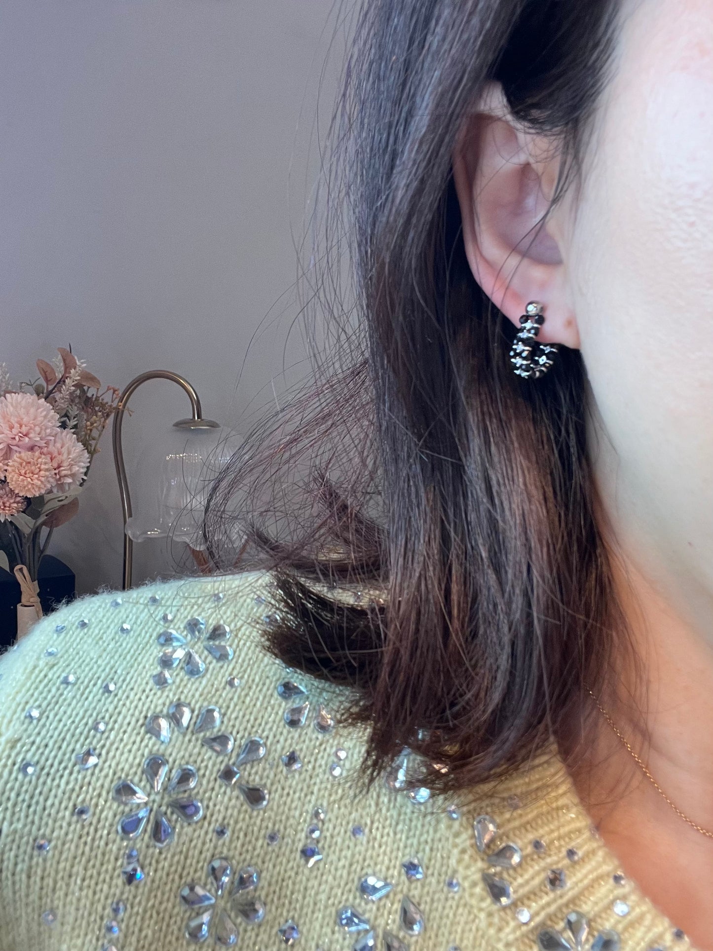 Wearing two pearl, turquoise and black spinel earrings